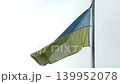 Zoom in on the Ukrainian flag fluttering in the wind 139952078