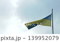Zoom in on the Ukrainian flag fluttering in the wind. 139952079