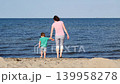 Mom plays with little child on sea shore 139958278
