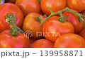 Fresh ripe red tomatoes with green stems closeup 139958871