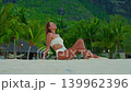 A concept of luxury vacation, freedom, beauty and tropical travel lifestyle. Ideal for summer promo content. View of woman walking along a tropical coastline. Mauritius 139962396