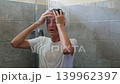 A teenage boy washes his hair with shampoo in the shower. Teen hygiene 139962397