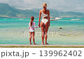 A mother and daughter looking at the beautiful ocean holding hands. travel and vacation concept with children 139962402