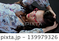 Brunette woman touching her hair while wearing red spectacles. Casual fashion and lifestyle concept. 139979326
