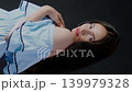 Brunette woman touching her hair while wearing red spectacles. Casual fashion and lifestyle concept. 139979328