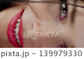 Smiling brunette woman with hair strands over her face. Natural beauty and happy emotions closeup. 139979330
