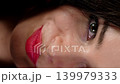 Smiling woman looking through colorful spectacle frames held near her eyes. Happy emotions and clear vision concept. 139979333