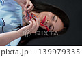 Brunette woman holding two different pairs of glasses in her hands comparing frames for choice. Buying optics and accessories. 139979335