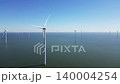 Wind turbines produce energy in the North Sea, wind farm power plant view from height, green energy, alternative energy sources. 140004254