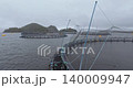 Large fish farm in the water with nets under cloudy sky as background 140009947