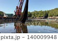 Crane lifting aquaculture net at fish farm 140009948