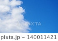 Bright clouds move across blue sky on sunny day. Time is during midday when light is strong and clear. Atmosphere shows natural beauty in simple way. One half of sky is blue, other half is in clouds 140011421