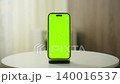 Smartphone with Green Screen on Table 140016537