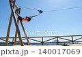 Adult woman having fun on zipline 140017069