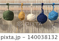 Balls of yarn on metal bar of vertical rug-weaving loom slightly swaying in wind. Ancient carpet weaving craft, workshops and regional and international festivals. Creating traditional oriental rugs 140038132