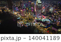 Cinematic aerial timelapse of downtown Ho Chi Minh City at night with illuminated skyscrapers, vibrant city lights, busy traffic and the Saigon River waterfront in Vietnam's financial district. 140041189