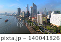 Cinematic aerial view of Ho Chi Minh City skyline along the Saigon River with modern skyscrapers, waterfront development and urban traffic in the city's financial district in Vietnam. 140041826