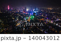 Cinematic aerial timelapse of Ho Chi Minh City at night with illuminated skyscrapers, vibrant city lights, busy streets and modern urban skyline in Vietnam. 140043012