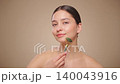 Young beauty woman using a natural jade face roller 140043916