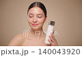Smiling woman holds bottle with cosmetic milk 140043920