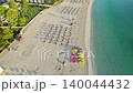 Mallorca coastal paradise offers sweeping sandy beach with vibrant turquoise sea leisure loungers. 140044432