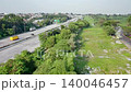 Aerial View of Urban Highway Traffic and Green Landscape in Daylight 140046457