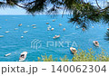 high angle view of boats in blue sea near rocky shore 140062304