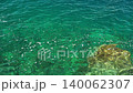 close up of crystal clear green sea water over rocks. 140062307