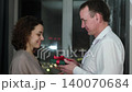 Happy Valentine's Day. A man gives his beloved woman a gift. Husband gives his wife pleasant surprises 140070684