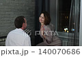 A woman dances for her husband in the evening at home. A man looks lovingly at his woman. Family well-being concept 140070686