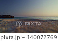 Aerial view of a quiet coastline and deep blue sea after sunset. 140072769