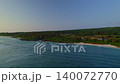 Aerial view of a quiet coastline and deep blue sea after sunset. 140072770