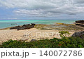 Yoron Island under a cloudy sky: Coastline near Yuinooka and emerald green sea (left pan view) 140072786