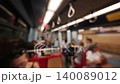Passengers seated and standing inside a subway train, with visible handrails and blurred backgrounds, showcasing the daily commute experience in an urban environment 140089012