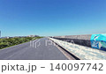 Bicycle POV ride: Action camera video of wind turbines and blue sky on a coastal embankment road. 140097742