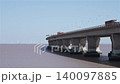 A truck crosses a bridge over the sea, with an offshore wind farm in the background - fixed camera footage of coastal transport. 140097885