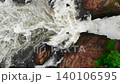 Aerial view of rushing whitewater river cascading through rocky canyon . Media 140106595