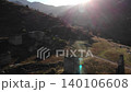 Sunlit Mountain Valley with Winding Rural Road and Lens Flare . Media 140106608
