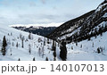 Aerial view of snow covered mountain peaks under a clear blue winter sky . Media 140107013