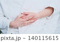 A man strokes the hands of a woman in a bathrobe 140115615