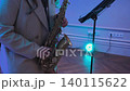 A woman plays the saxophone at a celebration 140115622