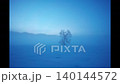 A lone tree stands in the snowy fields of the Chikuma River as morning mist rises before dawn 140144572