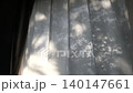 Natural light streaming in through the curtains and the silhouette of trees 140147661