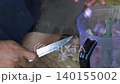 Butcher cuttingButcher cutting raw meat on a wooden chopping block	 raw meat on a wooden chopping block	 140155002