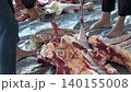 Butcher cuttingButcher cutting raw meat on a wooden chopping block	 raw meat on a wooden chopping block	 140155008