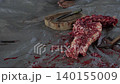 Butcher cuttingButcher cutting raw meat on a wooden chopping block	 raw meat on a wooden chopping block	 140155009