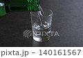 韓國燒酒 - 將冰鎮韓國燒酒（韓國傳統蒸餾酒）倒入玻璃杯中 140161567
