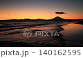 At Kugenuma Beach, the waves at the waterline are bathed in orange light after sunset, and the silhouette of Mount Fuji is visible. 140162595