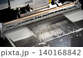 Automated stencil printer applying solder paste onto PCB in SMT production line for electronics assembly 140168842