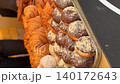 Assorted pastries with chocolate and sugar coating displayed on a bakery tray background video 140172643